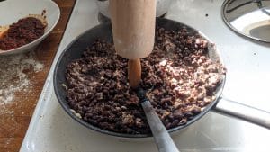 Mashing refried beans with a spoon