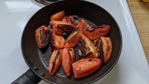 Charred tomatoes in a skillet